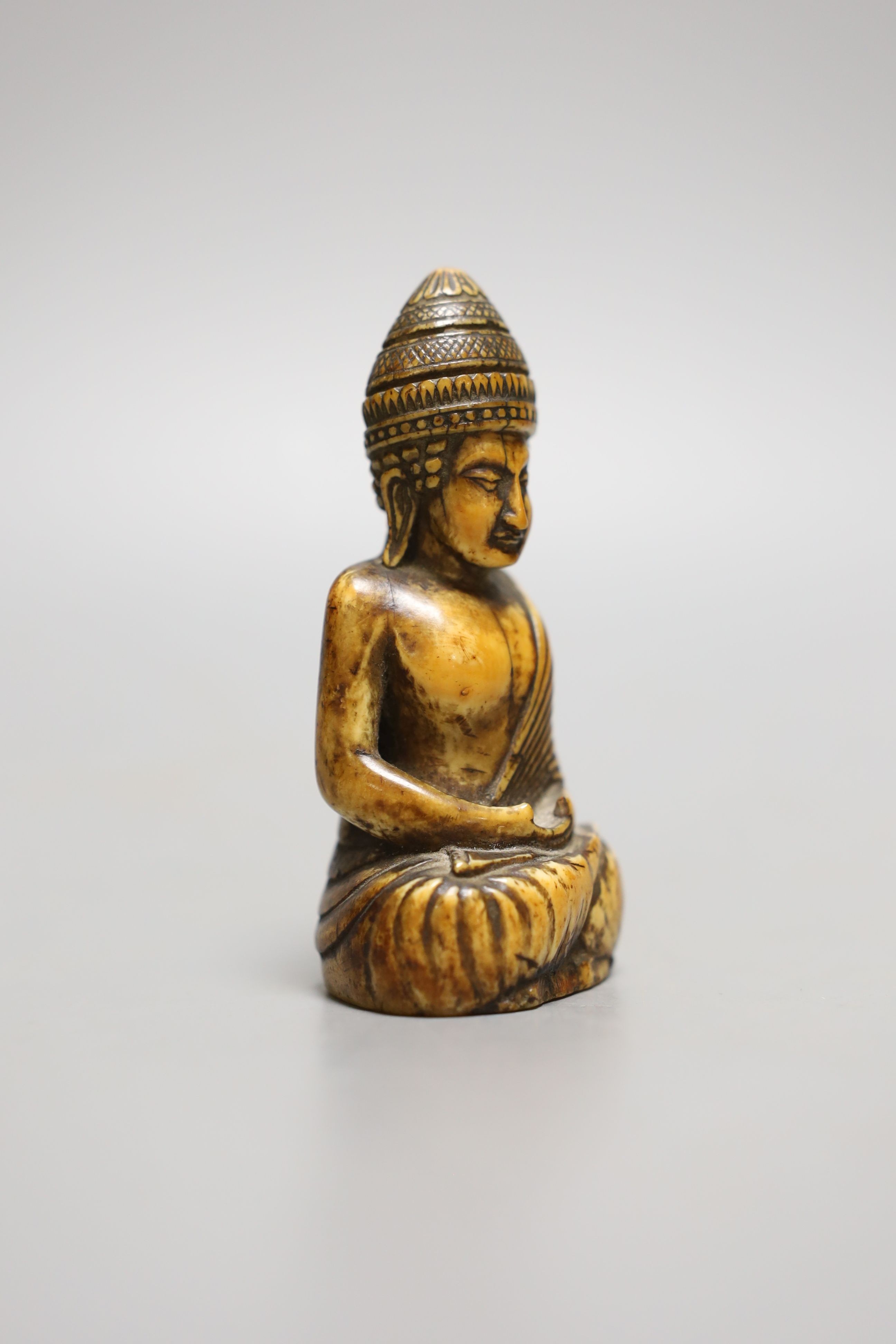 A Thai ivory buddha, probably 8th / 9th century, 9cms high.